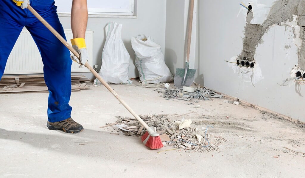 Post-construction cleaning in Edmonton — dusting a freshly built interior
